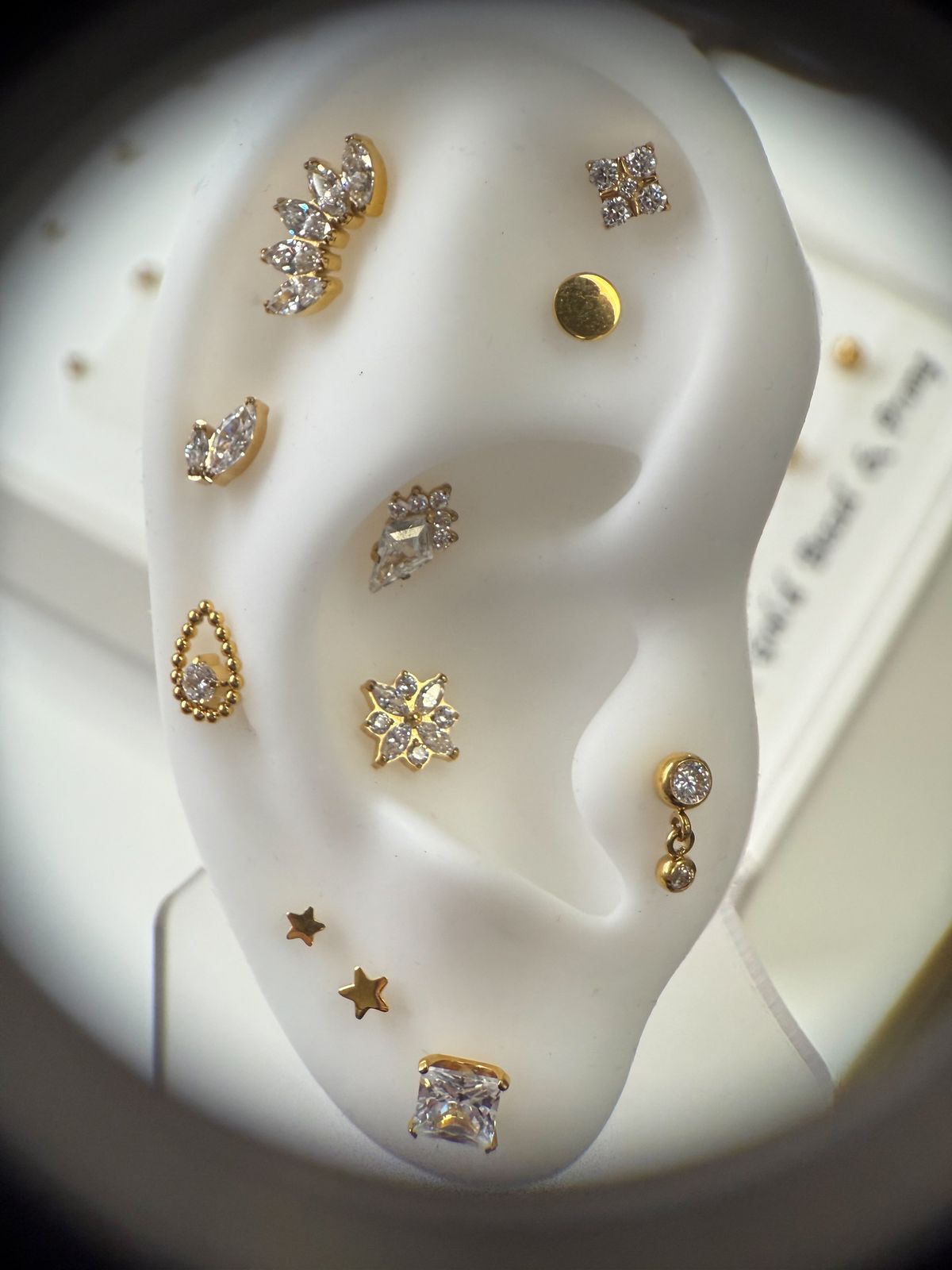 Curated ear layout with gold piercing jewelry