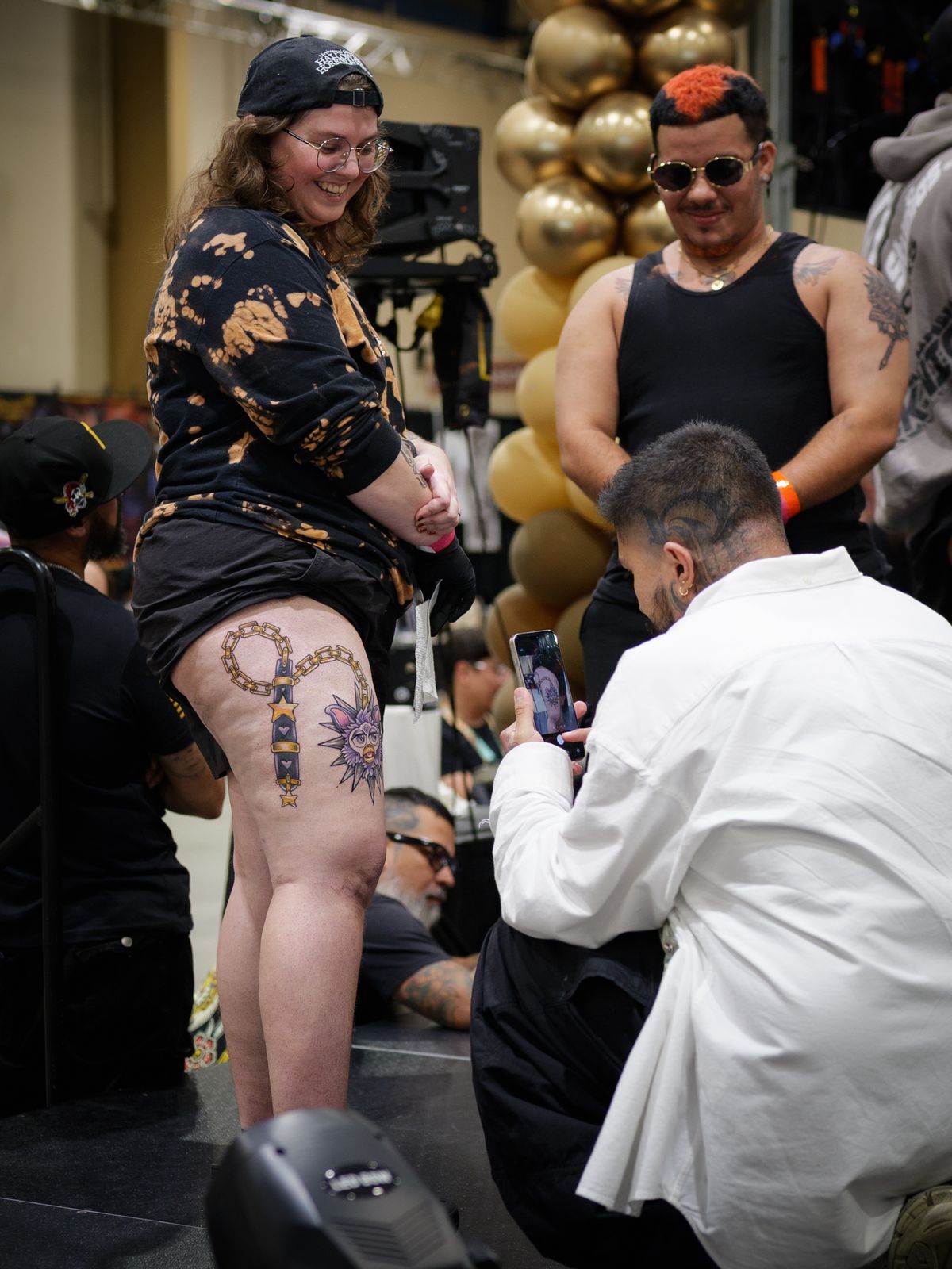 Clients showing fresh leg tattoos