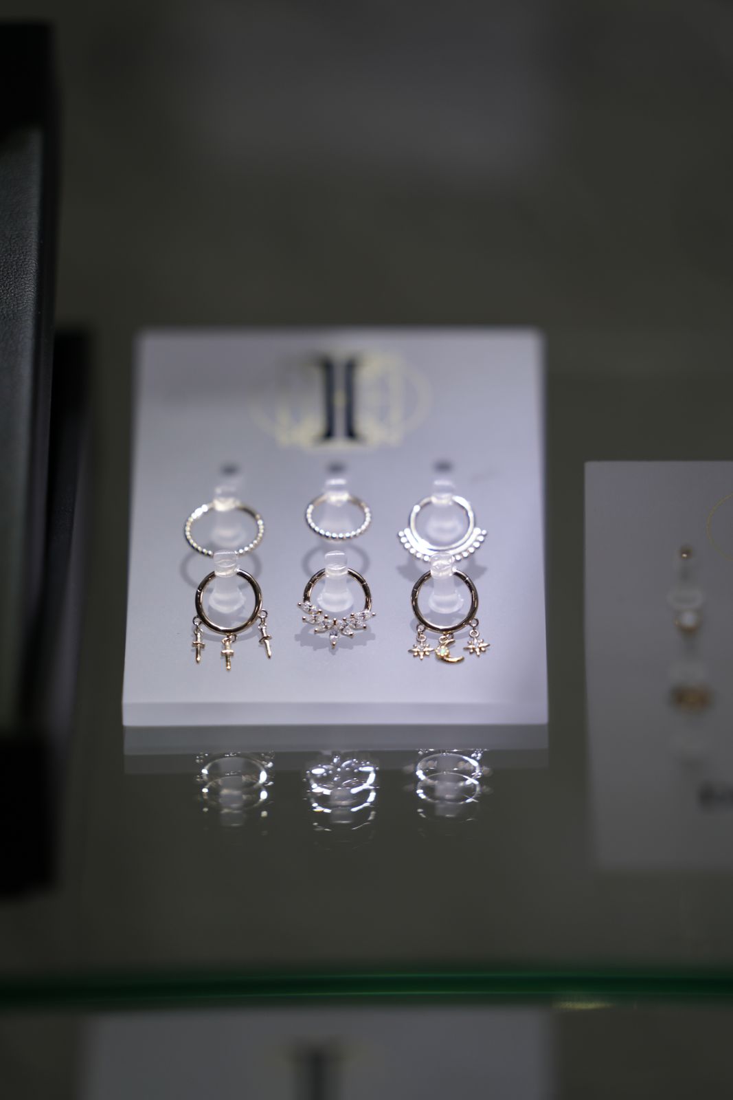 Piercing jewelry on display in a Fine Ink studio
