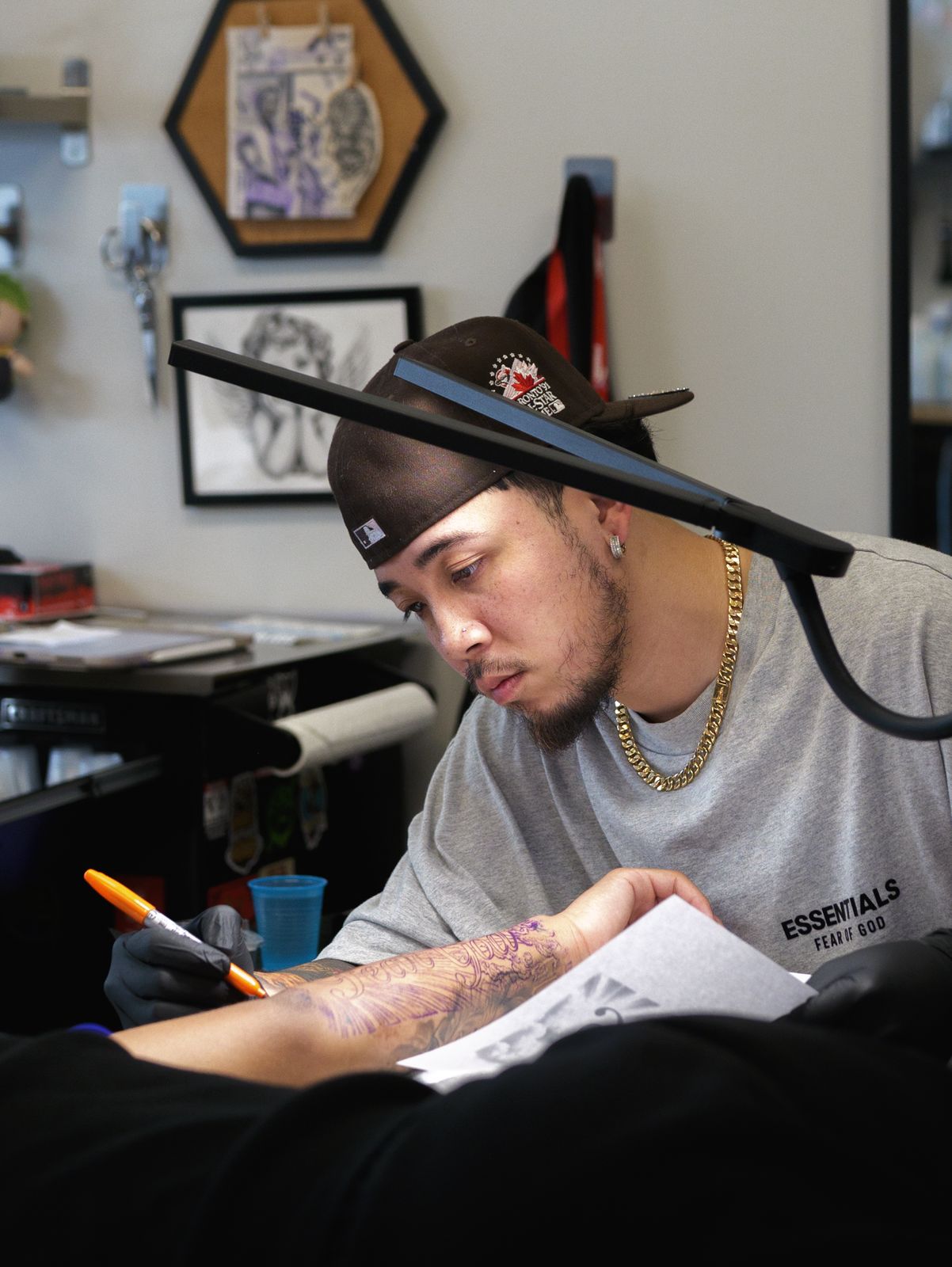 Artist freehand-drawing a custom design on a client