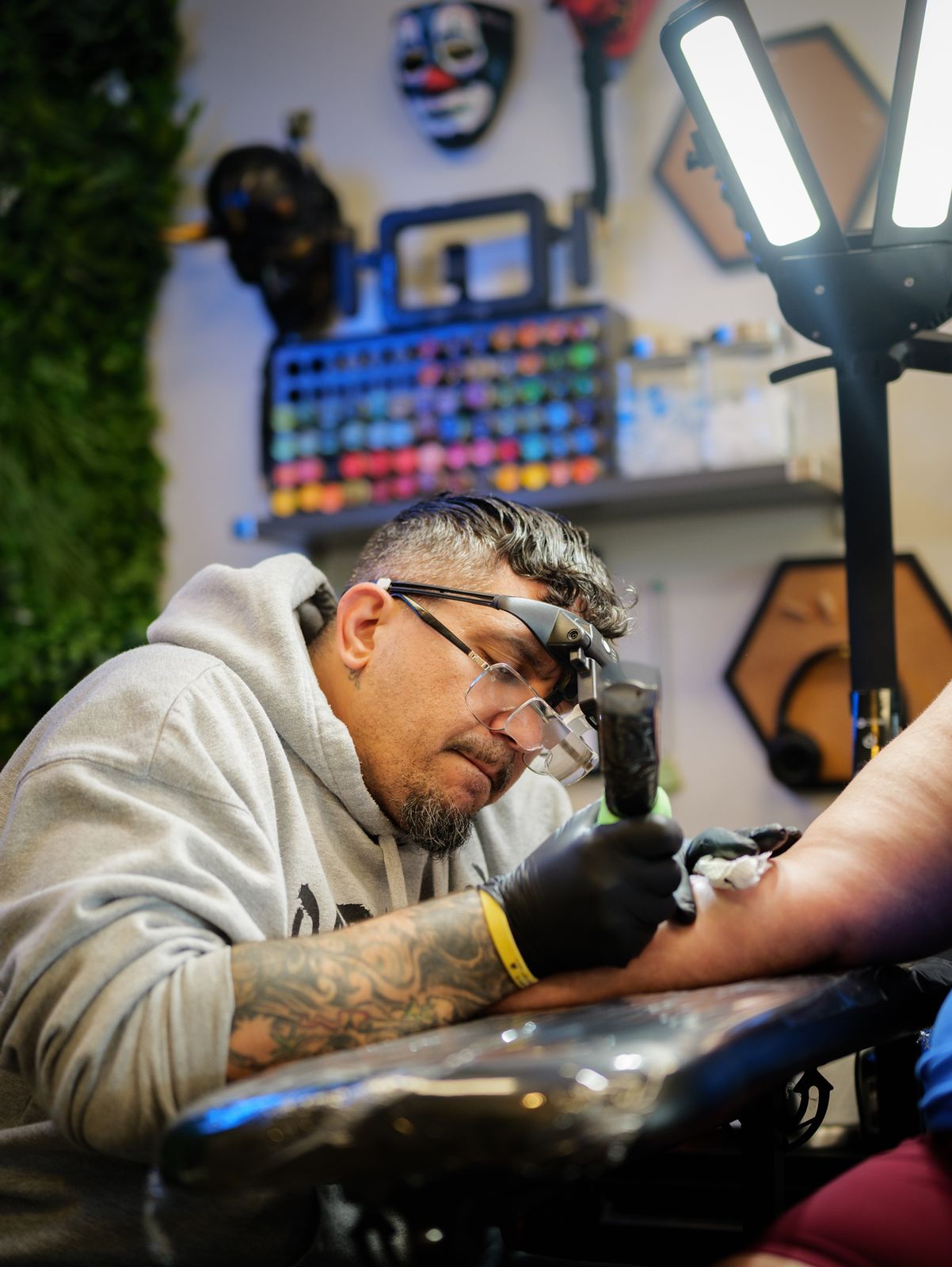 Artist working under a magnifier in a Fine Ink studio